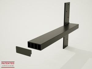 4 Black Original Free Floating Vanity Brackets secured to an unfinished wooden bathroom wall in a white bathroom with a window in the background.